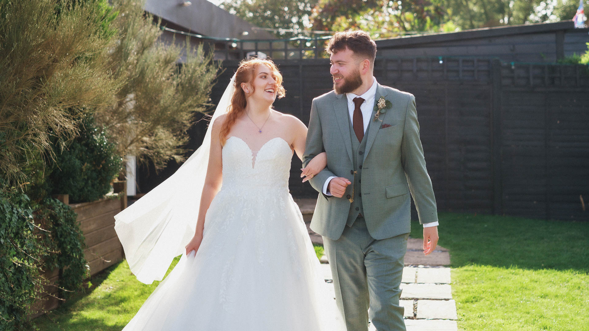 Lorna and Paul sharing a kiss outdoors with a glowing sunset behind them on their wedding day