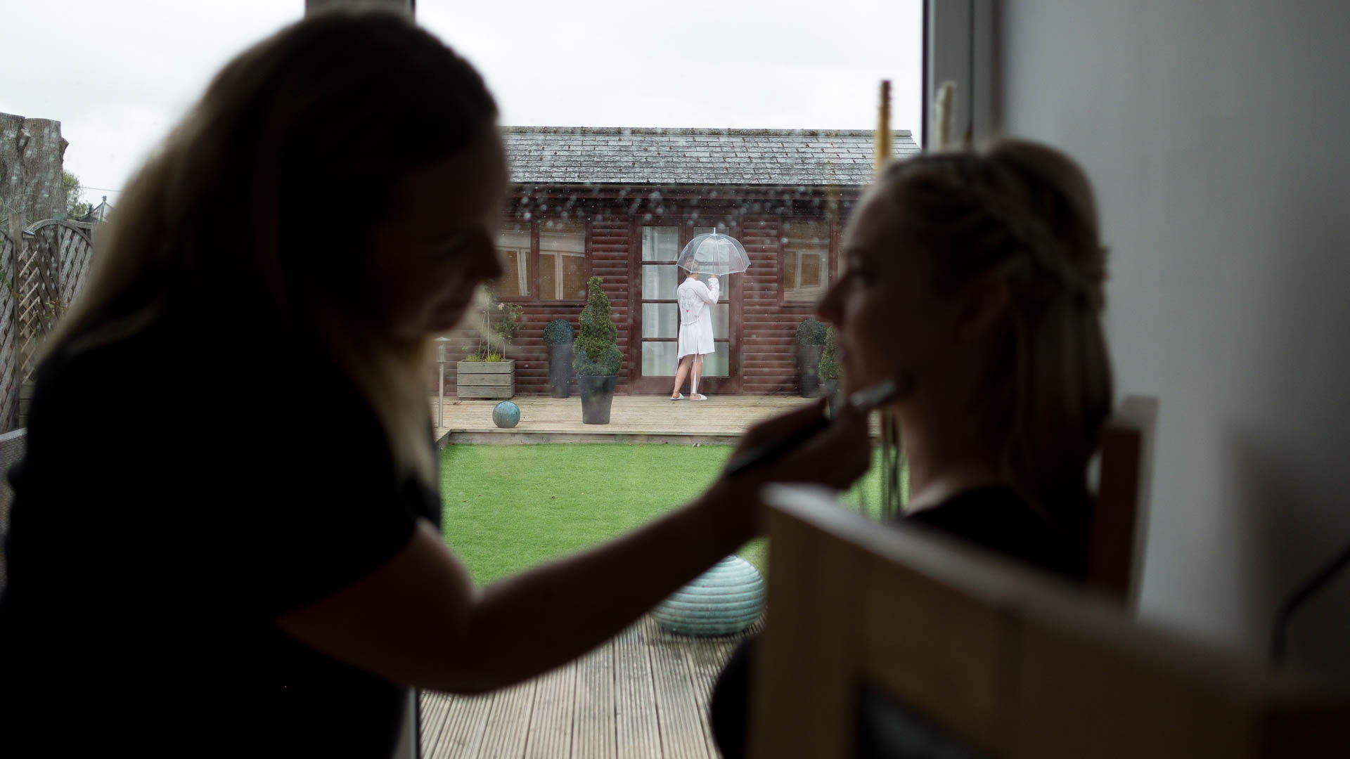 Bride holding umbrella in the rain during bridal prep, Heffs Photography, 