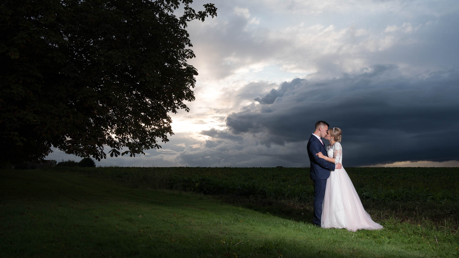 Cherie and Patrick sharing a kiss in a field at All Manor of Events, Heffs Photography, Suffolk Wedding Photographer