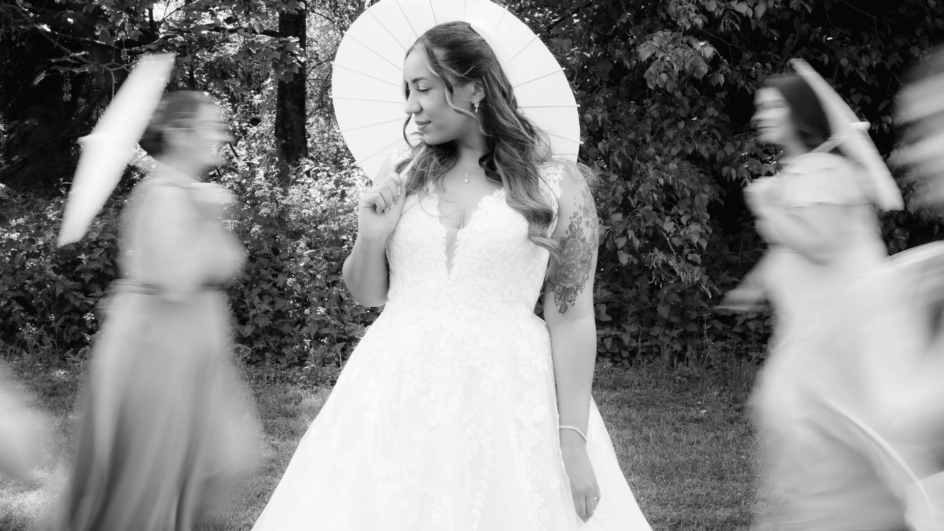 Bride posing with an umbrella, bridesmaids with motion blur in the background, Hintlesham Golf Club, Heffs Photography, ff