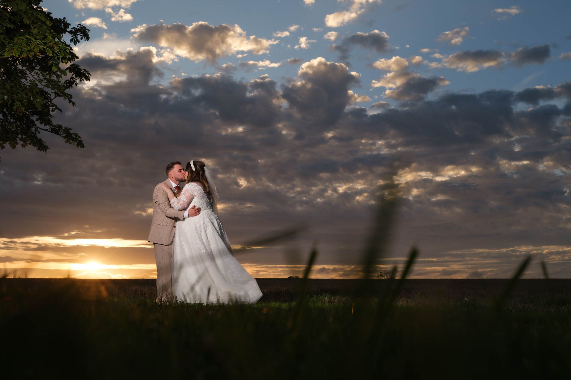 Couple kissing with a beautiful sunset at All Manor of Events Heffs Photography
